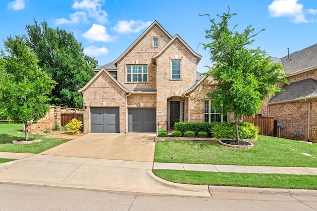traditional-style home with driveway, brick siding, fence, an attached garage, and a front lawn