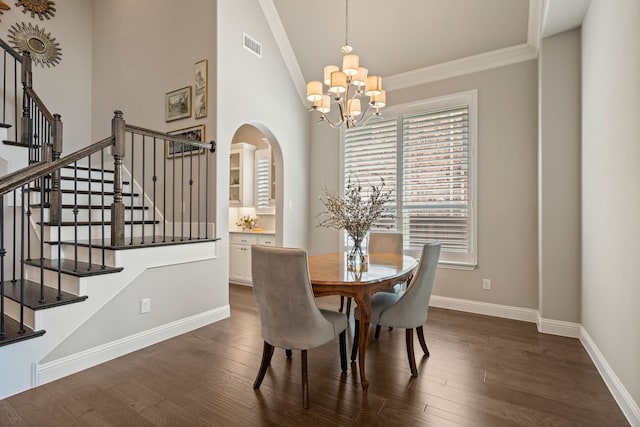 dining area with an inviting chandelier, dark wood-type flooring, and baseboards