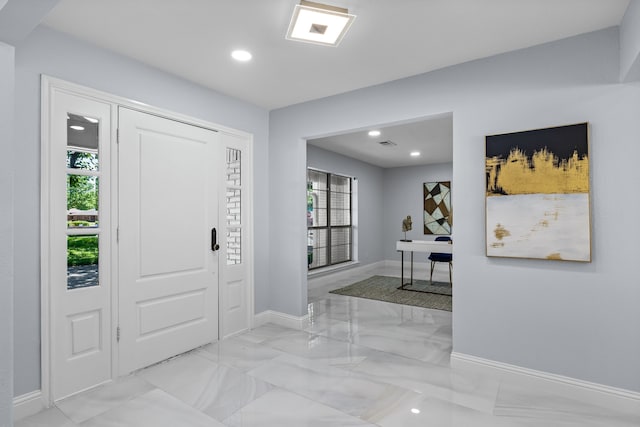 entryway with marble finish floor, baseboards, a healthy amount of sunlight, and recessed lighting