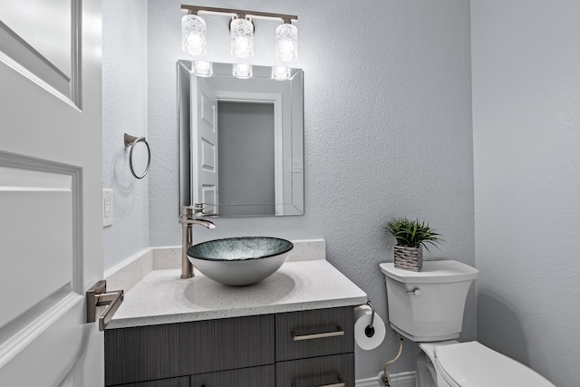 bathroom featuring toilet and vanity
