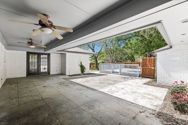 view of patio featuring fence, french doors, and a ceiling fan