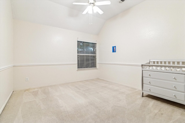 unfurnished bedroom with ceiling fan, lofted ceiling, carpet floors, and baseboards