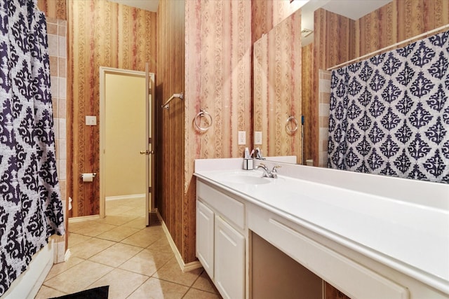 full bath with tile patterned flooring, baseboards, wallpapered walls, and vanity