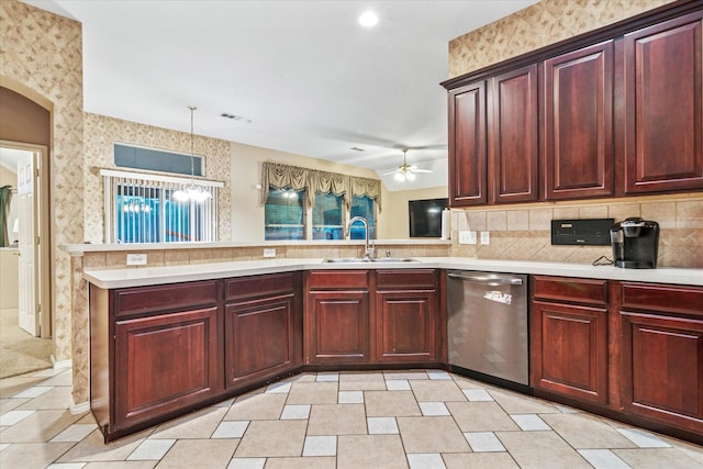 kitchen with stainless steel dishwasher, light countertops, dark brown cabinets, and wallpapered walls