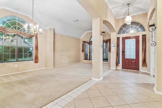 tiled foyer featuring arched walkways, carpet, a notable chandelier, and plenty of natural light