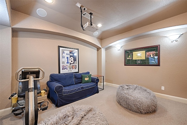 sitting room featuring carpet and baseboards