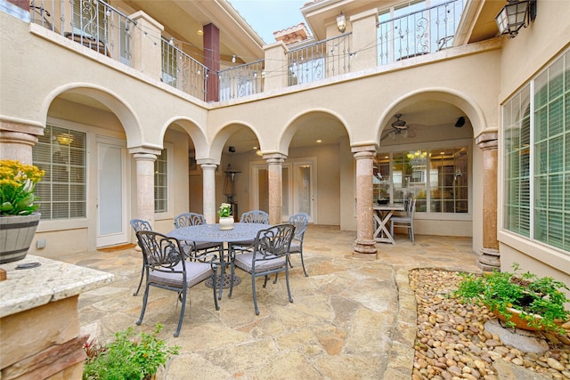view of patio / terrace featuring a balcony and outdoor dining space