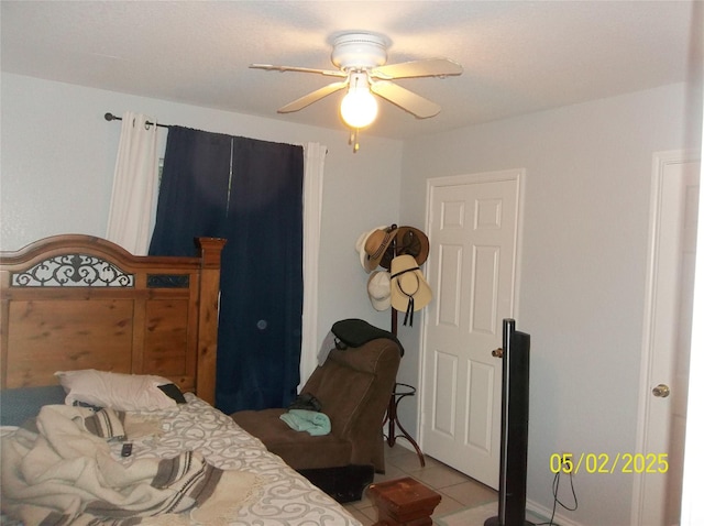 bedroom featuring light tile patterned floors and a ceiling fan