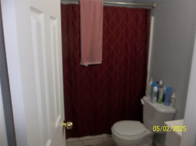 bathroom featuring toilet and tile patterned floors