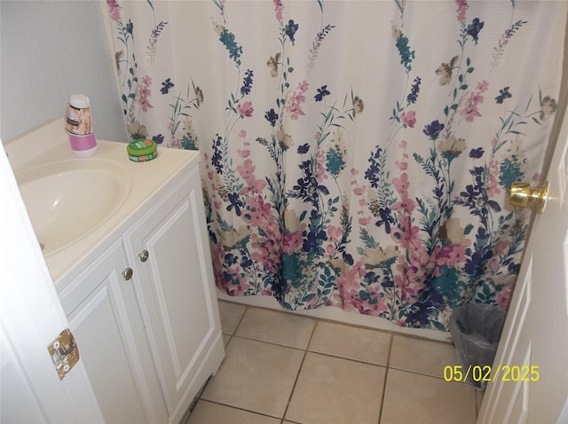 bathroom featuring tile patterned flooring, vanity, and curtained shower