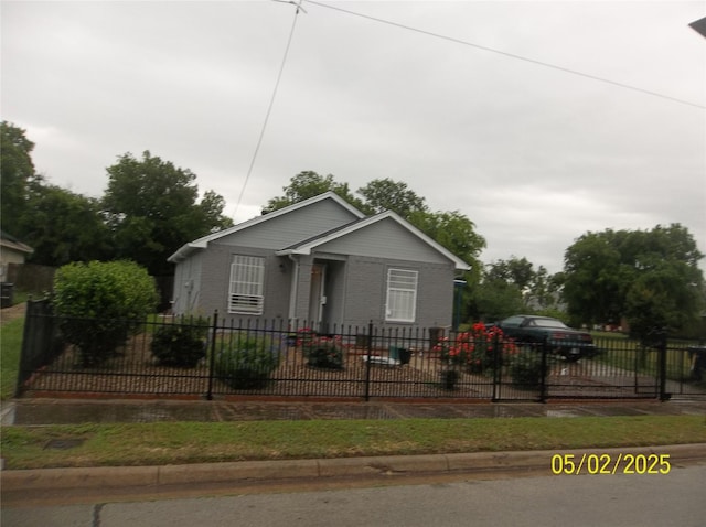 bungalow-style home featuring fence private yard and brick siding