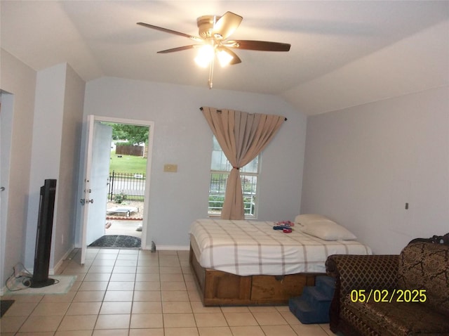 bedroom featuring light tile patterned floors, multiple windows, and vaulted ceiling