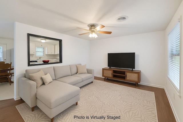 152 N Imperial Dr, Denison, TX 75020 - living area with wood finished floors, ceiling fan, and plenty of natural light