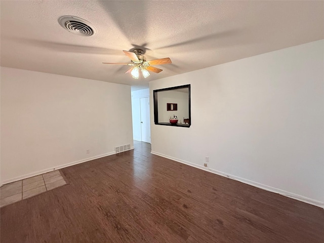 152 N Imperial Dr, Denison, TX 75020 - empty room featuring ceiling fan, dark wood-type flooring, and a textured ceiling