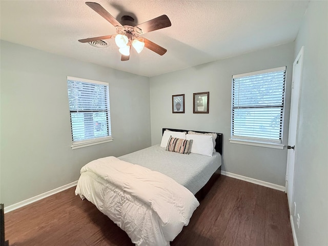 152 N Imperial Dr, Denison, TX 75020 - bedroom featuring dark wood-type flooring, a ceiling fan, and a textured ceiling