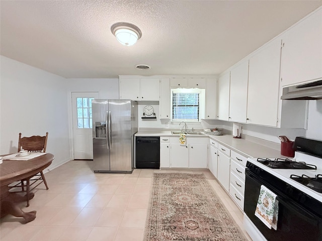 152 N Imperial Dr, Denison, TX 75020 - kitchen with black appliances, under cabinet range hood, light countertops, white cabinets, and a textured ceiling