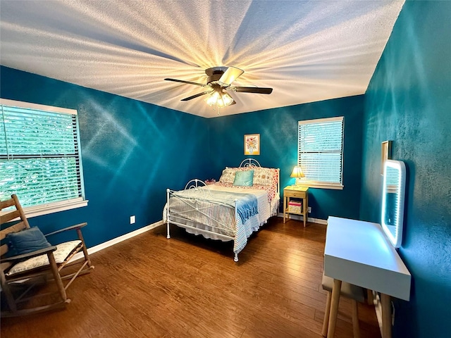 152 N Imperial Dr, Denison, TX 75020 - bedroom featuring wood finished floors, a textured ceiling, and a ceiling fan