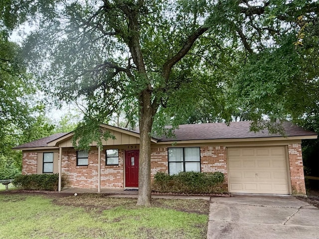 152 N Imperial Dr, Denison, TX 75020 - single story home featuring an attached garage, brick siding, concrete driveway, and a shingled roof