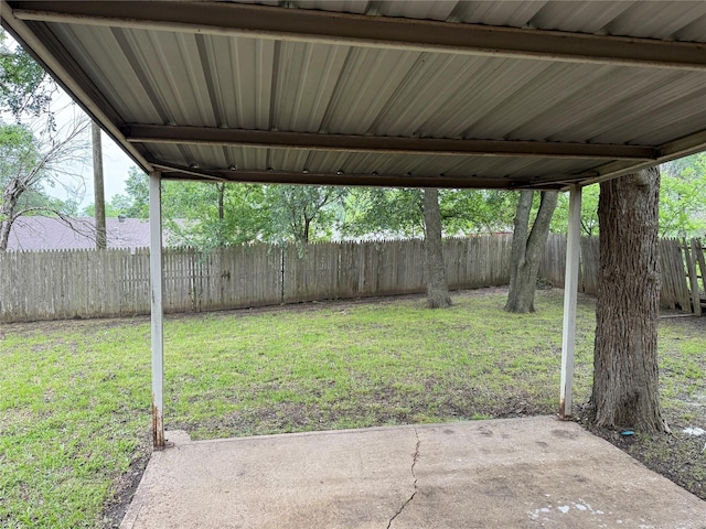 152 N Imperial Dr, Denison, TX 75020 - fenced backyard featuring a carport and a patio area