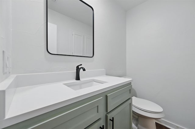 bathroom with toilet and vanity
