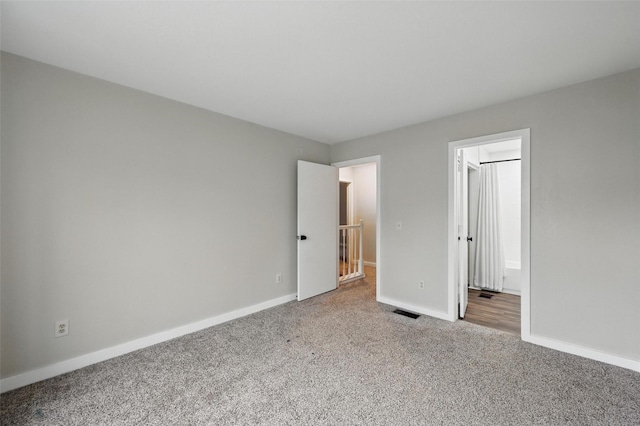 unfurnished bedroom with baseboards, carpet flooring, and visible vents