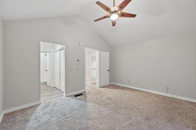 unfurnished bedroom featuring baseboards, carpet flooring, visible vents, and high vaulted ceiling