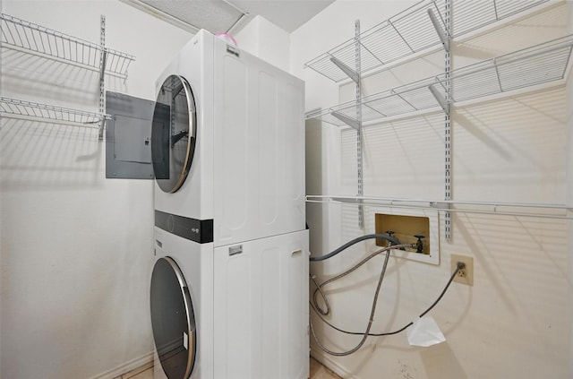 washroom with laundry area and stacked washer / dryer