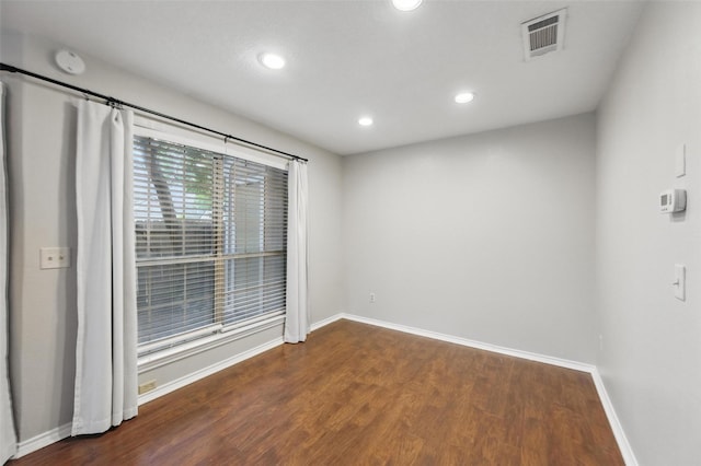 spare room featuring recessed lighting, baseboards, visible vents, and wood finished floors