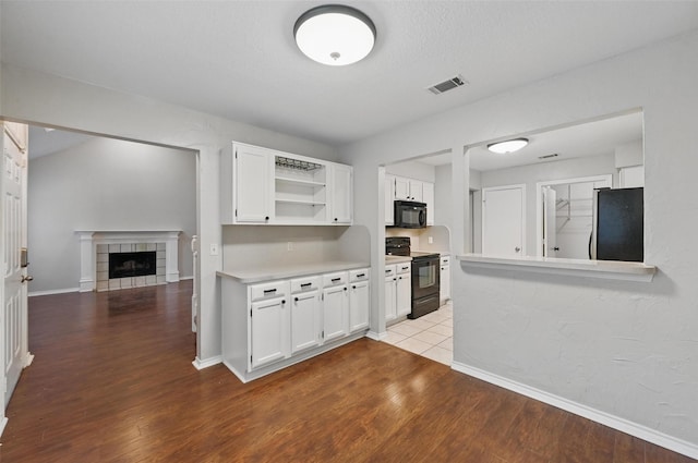 kitchen featuring black appliances, white cabinets, open shelves, and wood finished floors