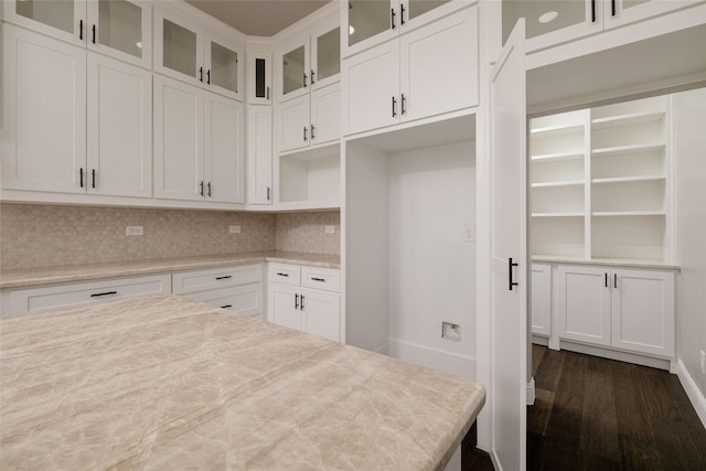 7196 Hawkeye Rd, Krum, TX 76249 - kitchen featuring white cabinets, glass insert cabinets, dark wood-style flooring, and backsplash