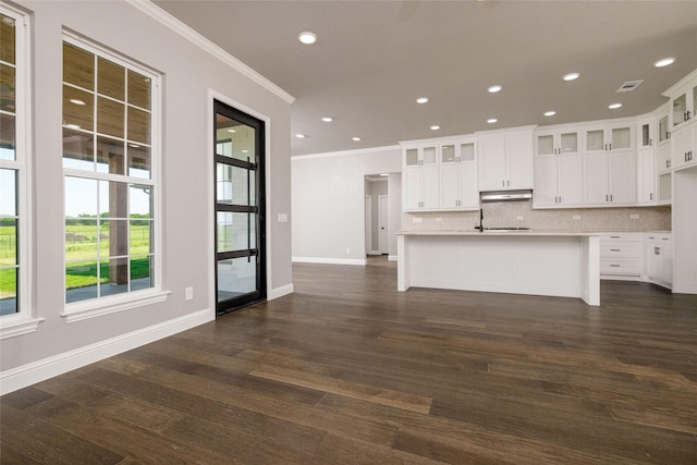 7196 Hawkeye Rd, Krum, TX 76249 - kitchen with crown molding, light countertops, decorative backsplash, dark wood-style floors, and glass insert cabinets