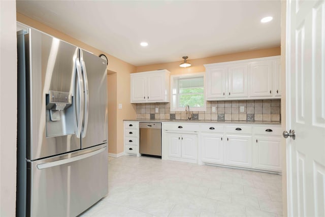 kitchen with recessed lighting, a sink, white cabinetry, decorative backsplash, and appliances with stainless steel finishes