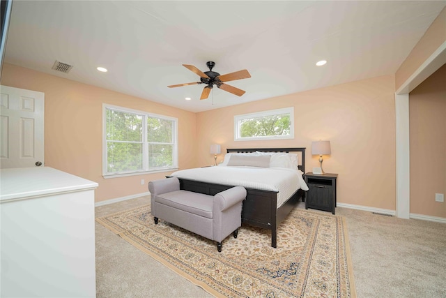 carpeted bedroom with baseboards, multiple windows, and visible vents