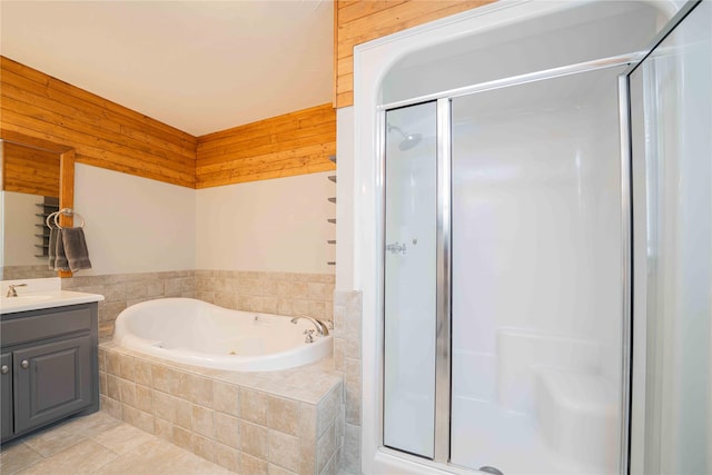 full bath featuring vanity, a whirlpool tub, a shower stall, and tile patterned floors