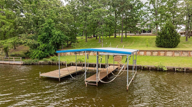 view of dock featuring a water view, a yard, and boat lift
