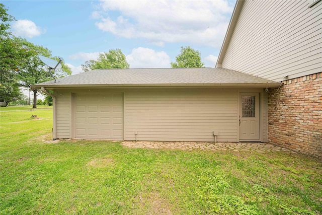 exterior space with a yard and a garage