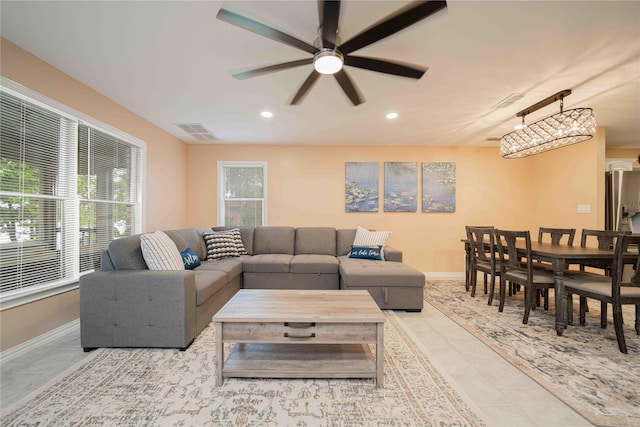 tiled living room featuring visible vents, baseboards, a ceiling fan, and recessed lighting