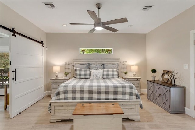 10 Holland St, Pottsboro, TX 75076 - bedroom featuring a barn door, baseboards, light wood-style floors, multiple windows, and recessed lighting