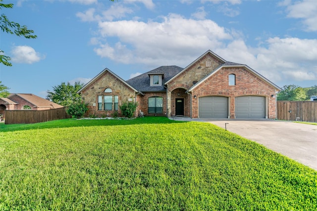 10528 Lago Vis, Quinlan, TX 75474 - view of front of property with brick siding, fence, an attached garage, concrete driveway, and a front lawn
