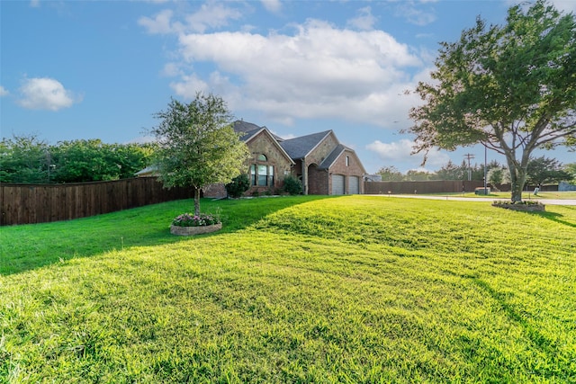 10528 Lago Vis, Quinlan, TX 75474 - view of home's exterior featuring a lawn, brick siding, a garage, and fence
