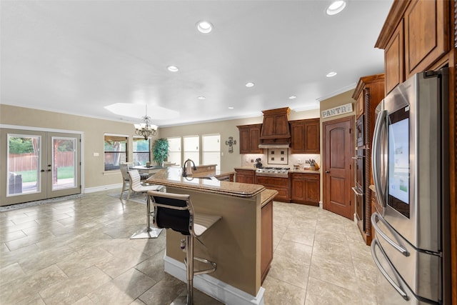10528 Lago Vis, Quinlan, TX 75474 - kitchen featuring a breakfast bar, ornamental molding, an inviting chandelier, a sink, and appliances with stainless steel finishes