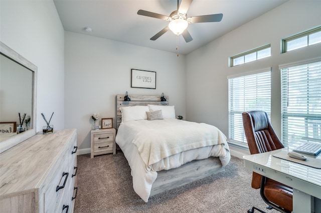 bedroom featuring baseboards, dark colored carpet, and ceiling fan