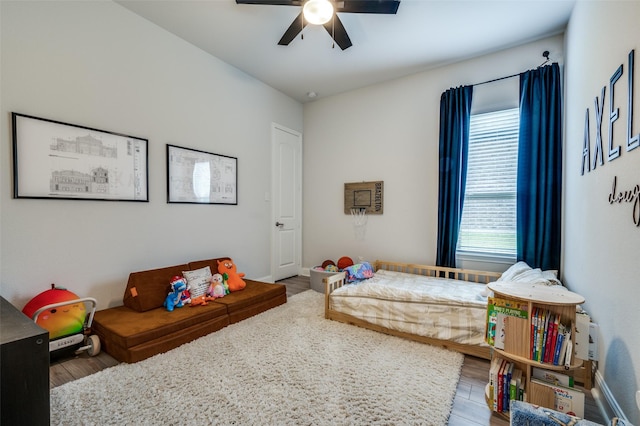 bedroom with a ceiling fan and wood finished floors