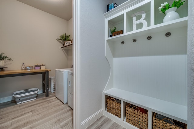 mudroom with independent washer and dryer and wood finished floors