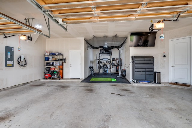 garage with electric panel and a garage door opener