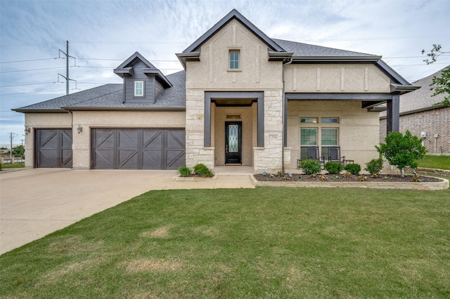 view of front of house with an attached garage, stone siding, a front lawn, concrete driveway, and roof with shingles