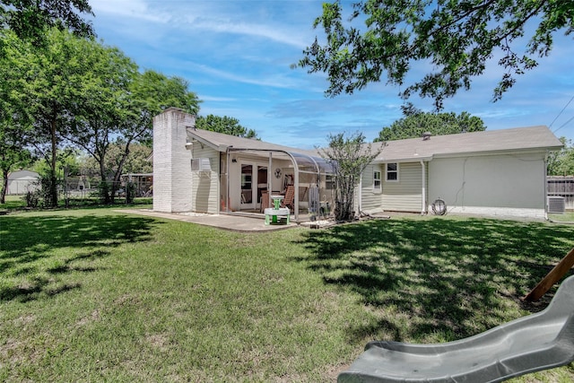 509 Oak St, Burleson, TX 76028 - back of property featuring a yard, a chimney, and a patio area