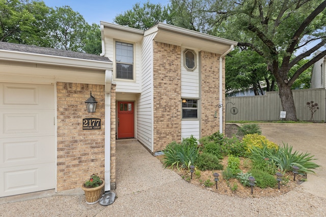 2177 Kessler Ct Unit 6, Dallas, TX 75208 - view of front of house featuring brick siding, driveway, fence, and a garage