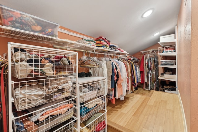 2177 Kessler Ct Unit 6, Dallas, TX 75208 - walk in closet with vaulted ceiling and wood finished floors