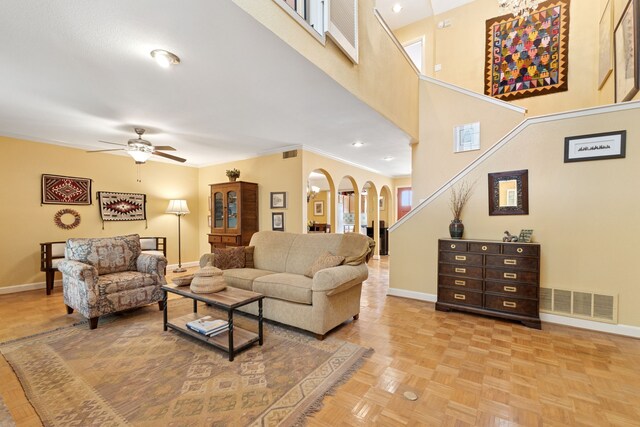 2177 Kessler Ct Unit 6, Dallas, TX 75208 - living area featuring a ceiling fan, baseboards, visible vents, arched walkways, and a high ceiling